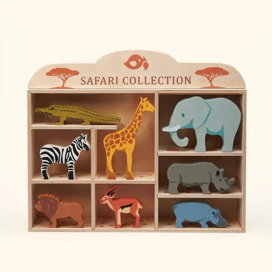 Wooden safari animals on some rocks